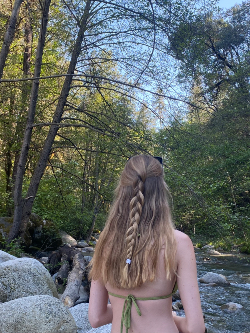 Photo of me from behind standing in front of a creek